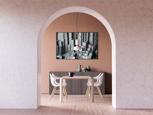 Example of a framed print with the Basalt Columns With Unusual Colouring design hanging on a dining room wall.