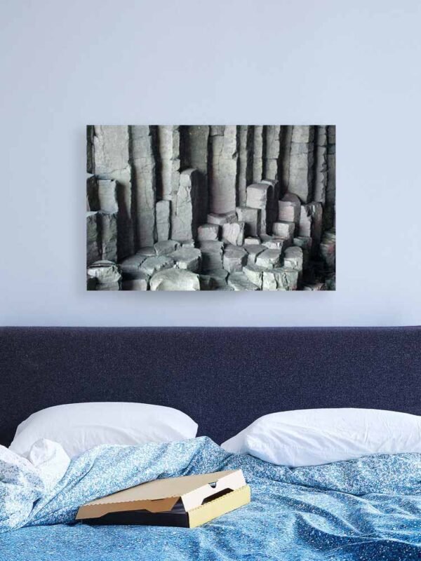 Example of a canvas print with the Basalt Columns With Unusual Colouring design hanging on a bedroom wall