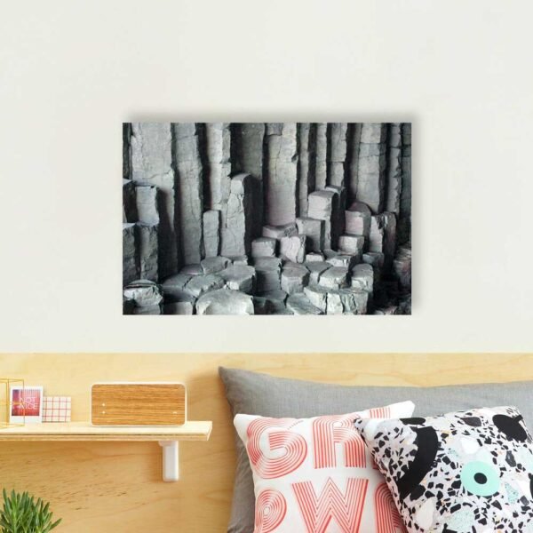 Example of a photographic print with the Basalt Columns With Unusual Colouring design hanging on a bedroom wall