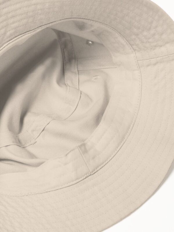 The inside of a bucket hat, showing the construction and stitching.