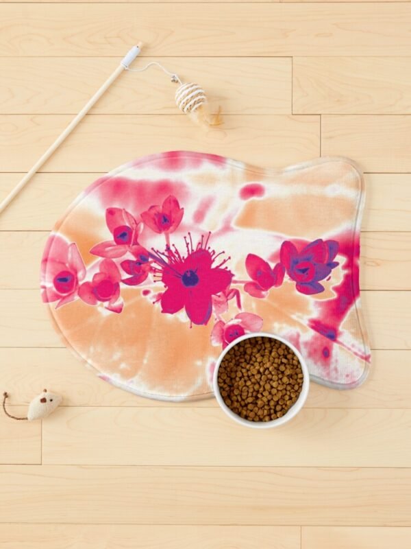 Alternative Hypericum fish shaped mat surrounded by cat toys and a bowl of food.