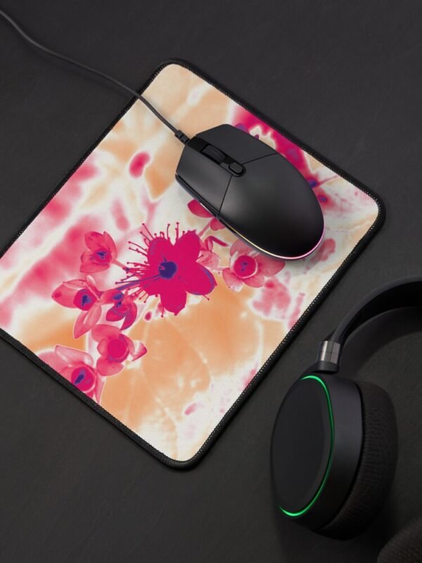 Alternative hypericum mouse pad with a black mouse sitting on it and black earphones just visible