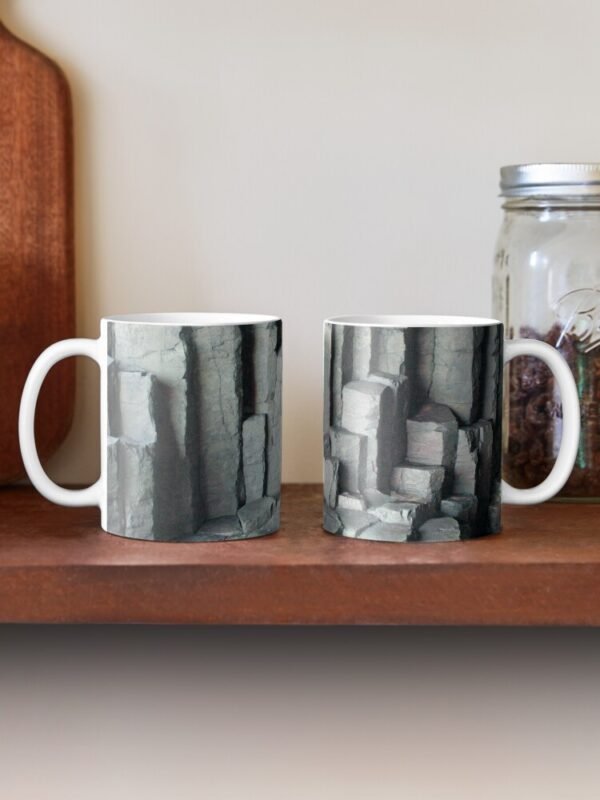 Basalt Columns Classic Mugs sitting on a shelf one with the handle to the left, the other with the handle to the right