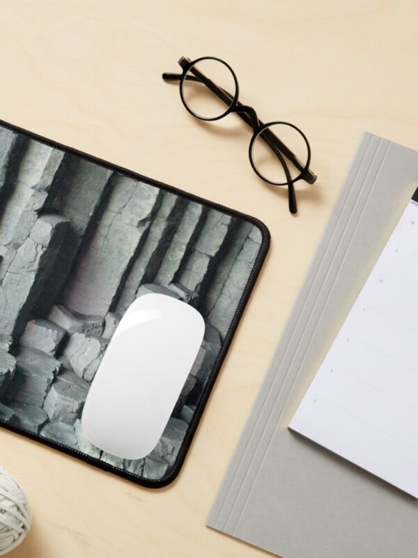 Basalt Columns Mouse Mat with a white mouse on the mat and stationery and spectacles nearby