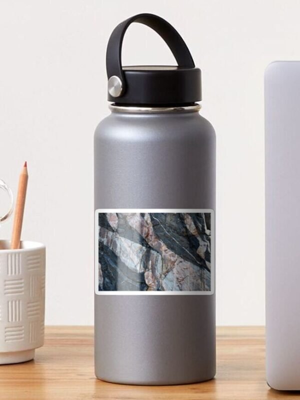 A water bottle with a sticker with the Geology Makes Art design printed onto it.