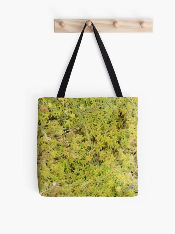 A Bed of Sphagnum Moss all over print tote bag hanging on a wooden set of pegs