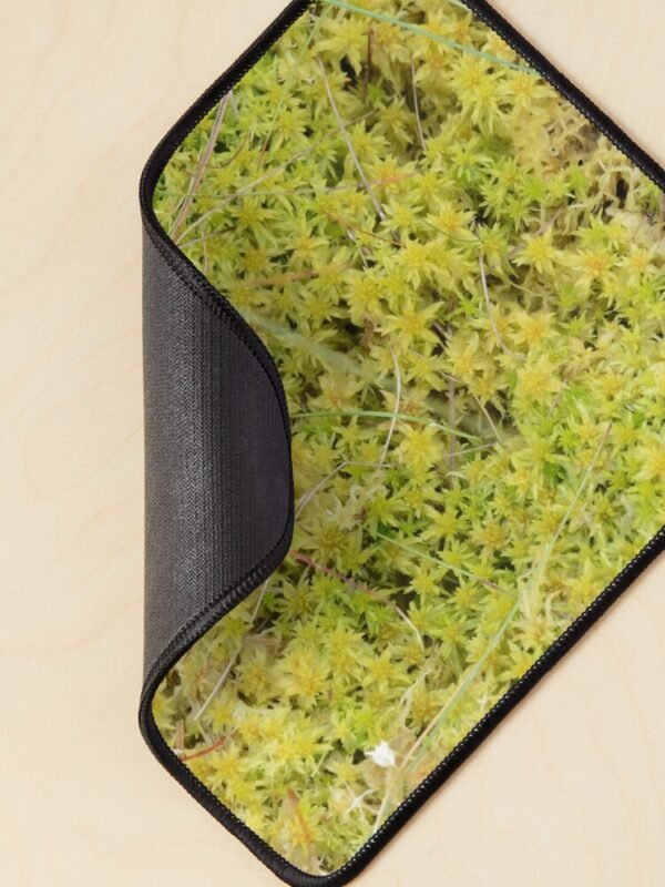 A Bed of Sphagnum Moss mouse mat curled over at one corner to show the backing