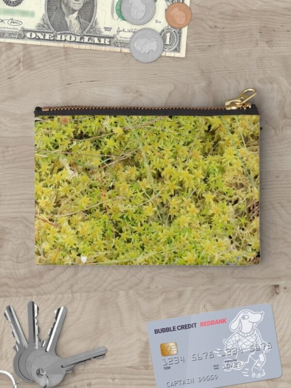 A Bed of Sphagnum Moss zipper pouch surrounded by money, keys and a credit card