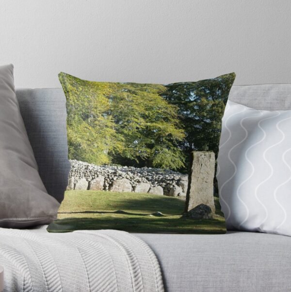 Cairns and Standing Stone Cushion / Throw Pillow on a grey sofa
