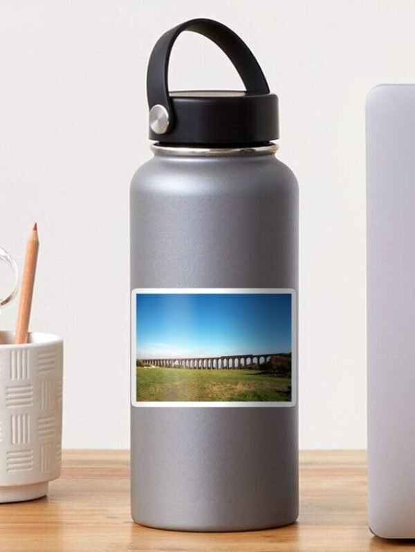 A water bottle with a sticker with a photo of a train running along the Culloden viaduct.