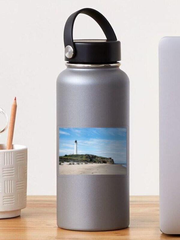 A water bottle sporting a transparent sticker which has the Lighthouse on a beach design.