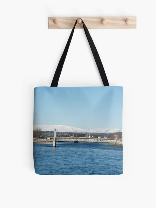 Ben Wyvis All Over Print Tote Bag hanging on a set of 4 wooden pegs