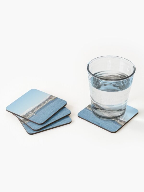 Ben Wyvis set of 4 Coasters with a stacked pile on the left hand side and on the right a coaster with a glass containing a clear liquid