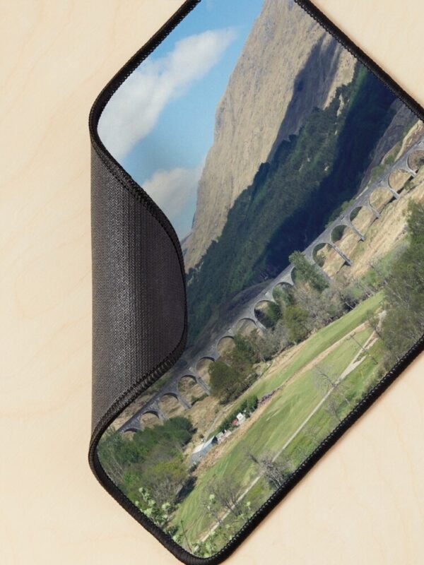 A mouse mat/pad with an image of the Glenfinnan viaduct on its front. The corner is curled to show the backing.