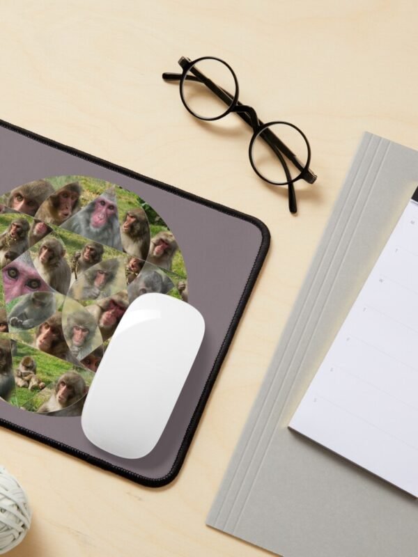 A mouse mat/pad with the Many Faces of A Snow Monkey design.