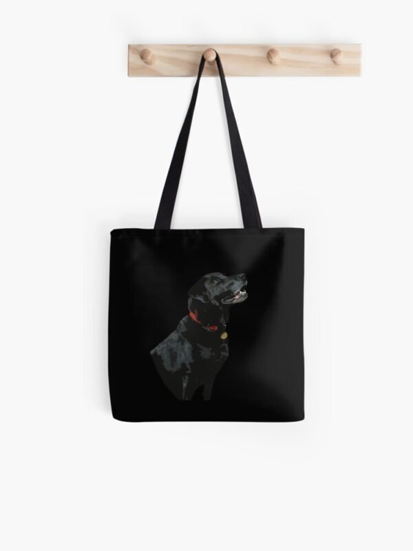 Adoration of a Black Labrador All Over Print Tote Bag hanging on a set of four wooden pegs
