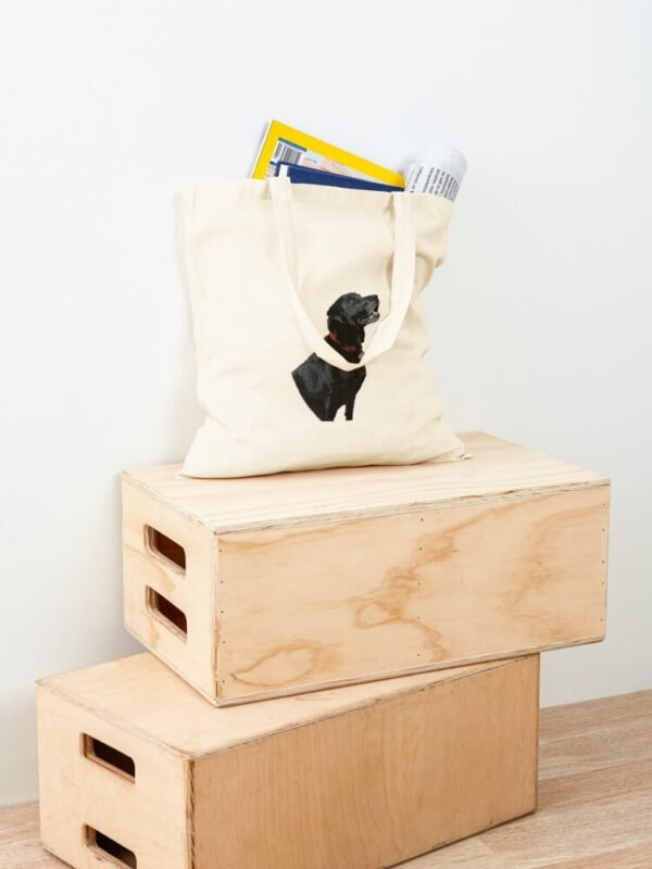 Adoration of a Black Labrador Cotton Tote Bag full of items and sitting on two wooden boxes