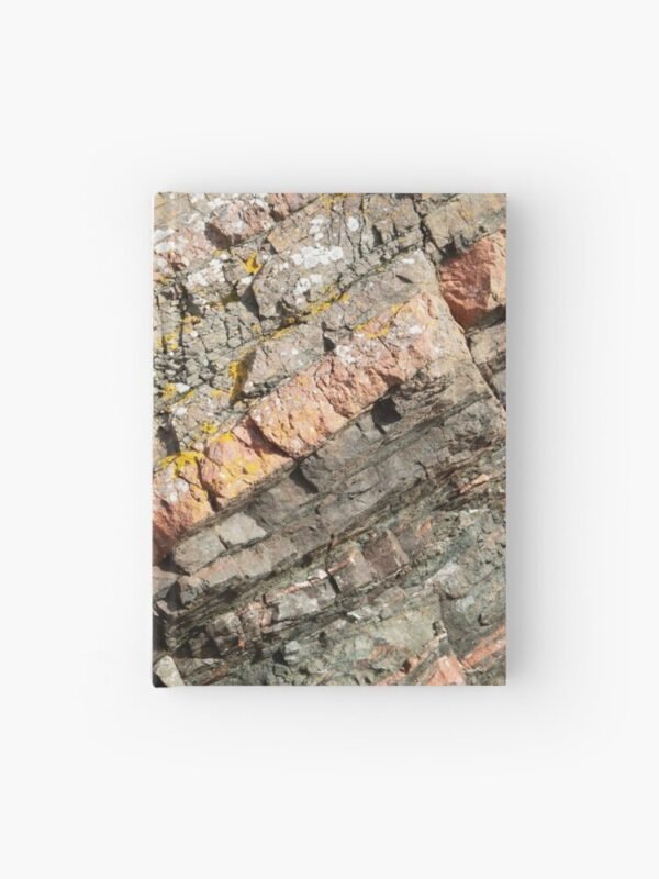 A hardcover journal with a close up image of different coloured layers of rock on its cover