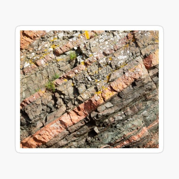 A sticker with the design of a close up image of different coloured layers of rock