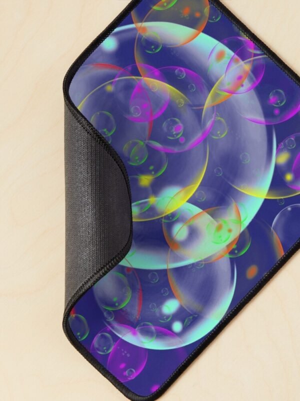A mouse mat/pad with an image of different sized, and coloured bubbles on its front... The corner is curled to show an example of the backing.