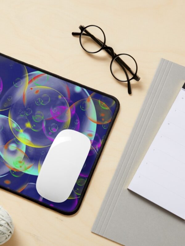 A mouse mat/pad with an image of different sized, and coloured bubbles on its front .