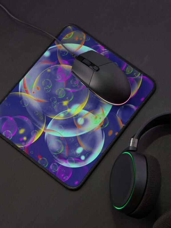 A mouse mat/pad with an image of different sized, and coloured bubbles on its front.